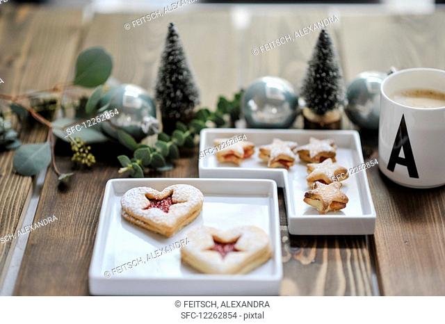 Two pastries in small bowls and a Christmas table decoration