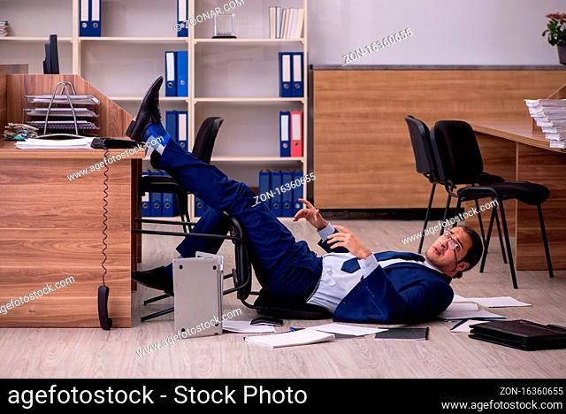 Young businessman employee unhappy with his work in the office