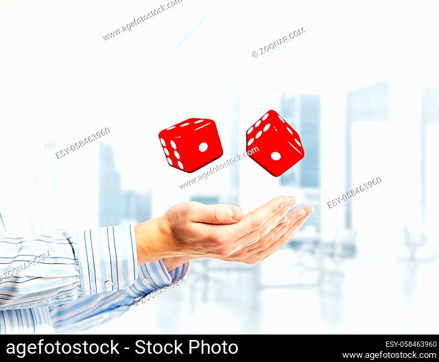 Close of businessman hands with dice as game concept. Mixed media