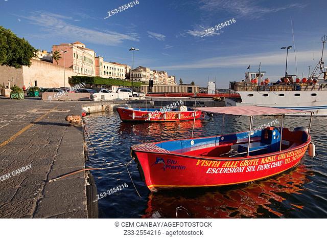 Red cruise boats near the waterfront buildings in the historic center at afternoon light, Ortigia, Syracuse, Sicily, Italy, Europe