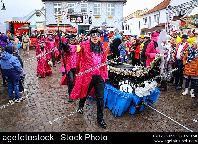 12 February 2023, Lower Saxony, Damme: Participants of the Damme Carnival have made the Venice Carnival their motto during the street carnival parade through...