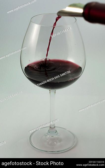 Large glass of wine being served with red wine