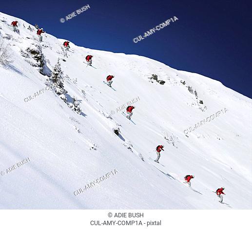 Sequence of male skier jumping down steep slope Digital Composite