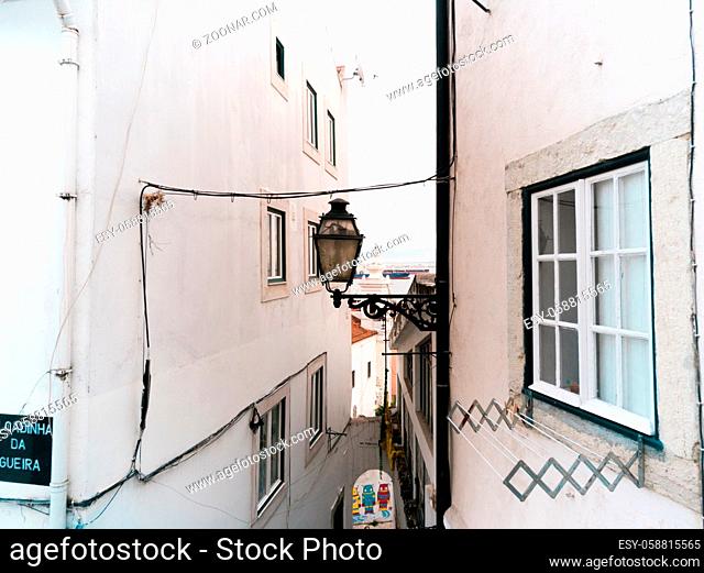view of the Tagus river with cargo sailing through the walls of houses, Lisbon