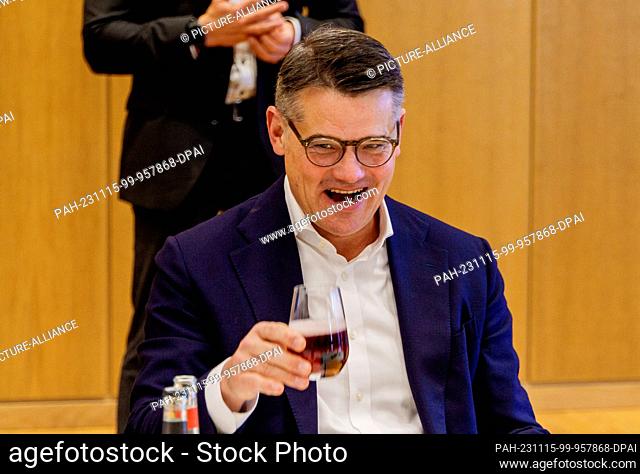 15 November 2023, Hesse, Wiesbaden: Boris Rhein (CDU), Minister President of Hesse, raises a glass of lemonade in the negotiating room