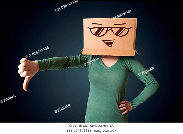 Young lady gesturing with a cardboard box on her head with smiley face