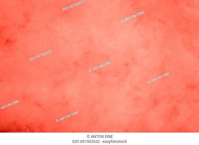 Coral pink color toned paper parchment background texture with stains