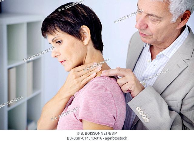 doctor examining patient's neck