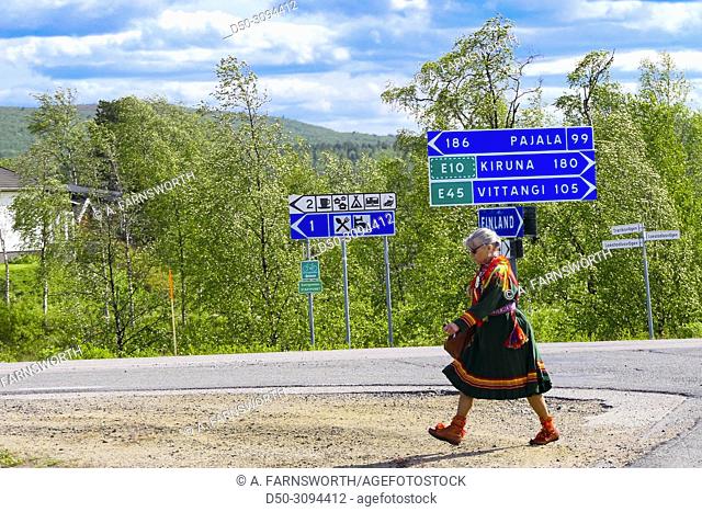 A Sami woman in traditonal outfit walks across a parking lot in Karesuando, Sweden's northernmost town on the border with Finland. Karesuando, Sweden