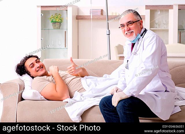 The old male doctor visiting young male patient