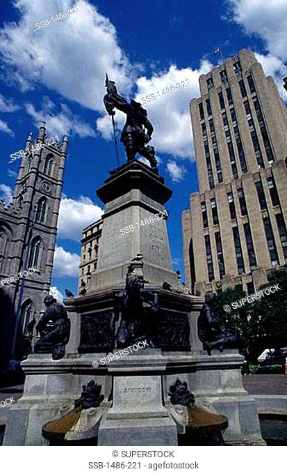 Paul Chomedey's statue with a church in the background, Notre Dame de Montreal, Place d'Armes, Montreal, Quebec, Canada