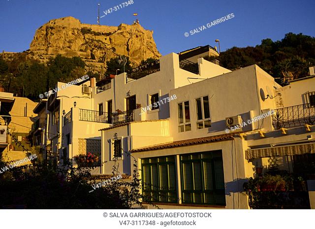 Houses in the neighborhood of Santa Cruz and in the background the Castle of Santa Barbara in Alicante, Valencia, Spain