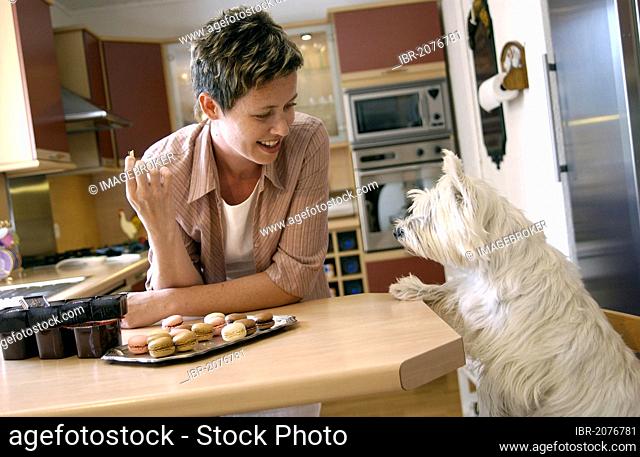 Woman and her dog in a kitchen