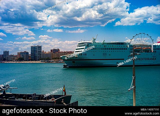 malaga, spain: street photography from the passeo del muelle dos (second dock promenade), along the harbour of malaga which opened in 2011