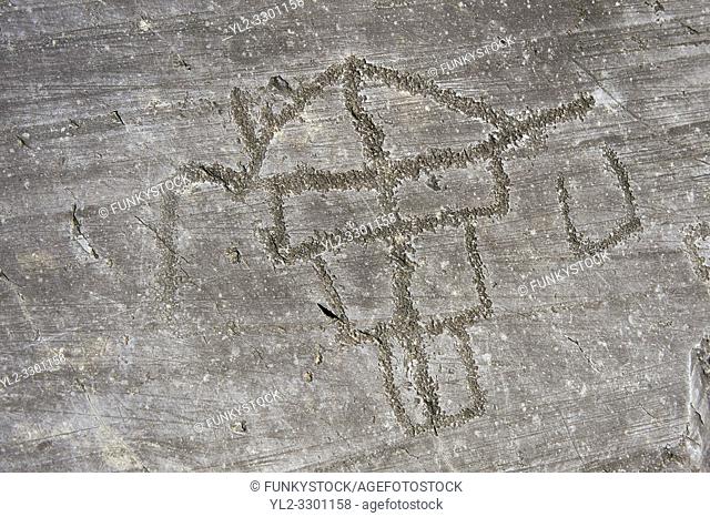 Petroglyph, rock carving, of two feet outlines. Carved by the ancient Camunni people in the iron age between 1000-1600 BC
