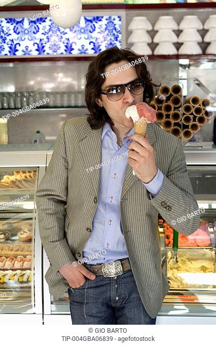 Man with cone in ice cream parlour