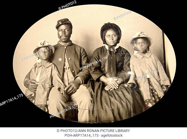 photograph of an African American, Civil War, Union soldier with his family. c1863-65