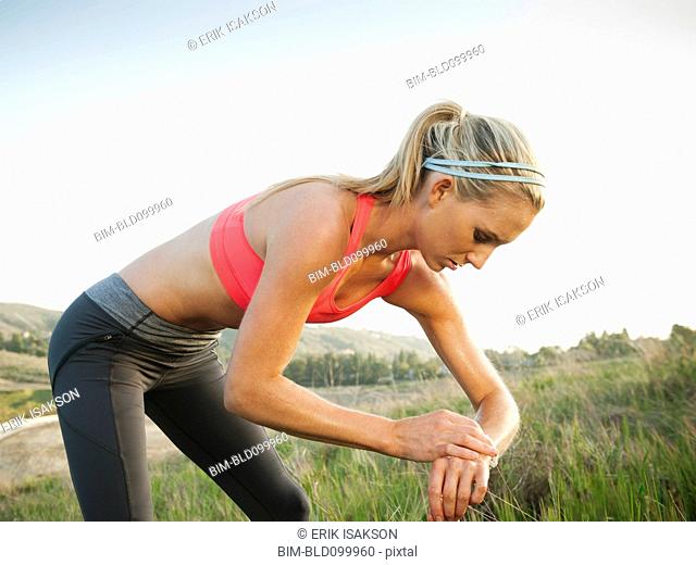 Caucasian woman taking her pulse after exercise