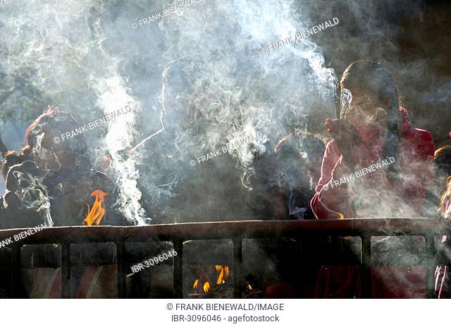 Pilgrims burning incense as an offering, Dakshinkali Temple or Dakshin Kali Temple