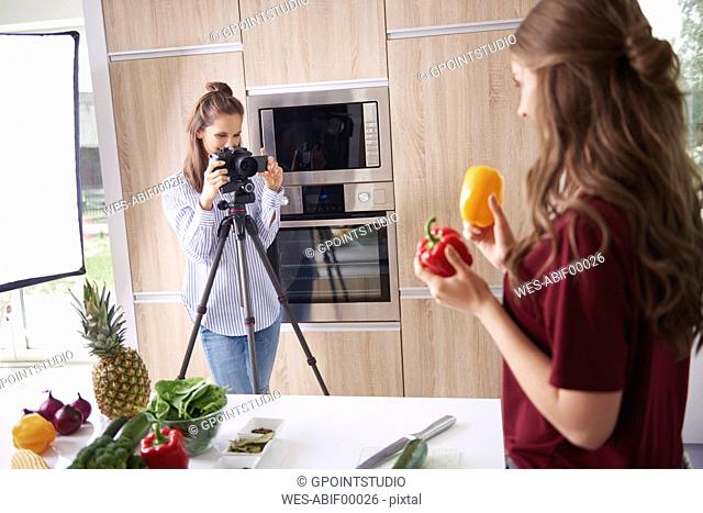 Woman recording friend while preparing healthy food