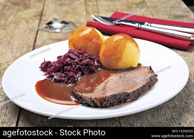 Sauerbraten (marinated pot roast) with dumplings and red cabbage