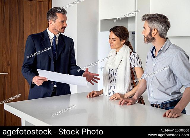 Real estate agent talking to couple