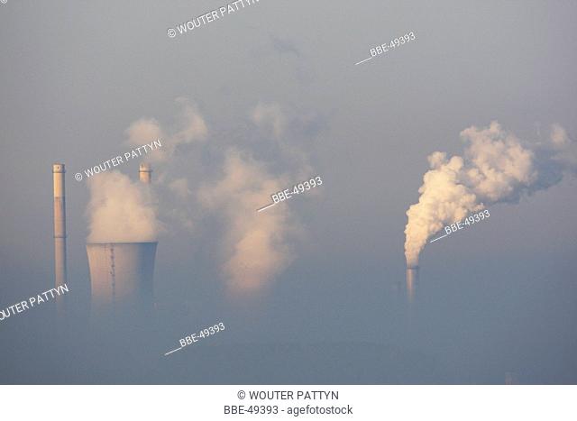 Electric power plant by sunrise in mist, Belgium