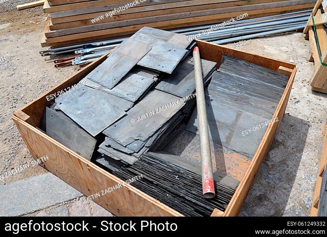 black tile rectangles in stack building or contruction materials on ground
