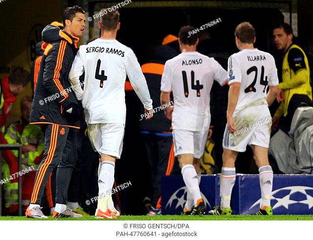 Madrid's Cristiano Ronaldo (L) speaks with his teammates Sergio Ramos (L-R), Xabi Alonso and Asier Illarramendi during the UEFA Champions League quarter-final...
