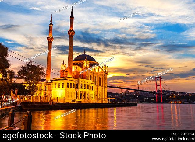 A Grand Imperial Mosque of Istanbul and the Bosphorus bridge in the night lights