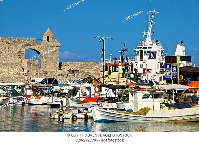 Fishing boats and ramparts, in Mandraki harbor, Rhodes town , Rhodes island, Greece