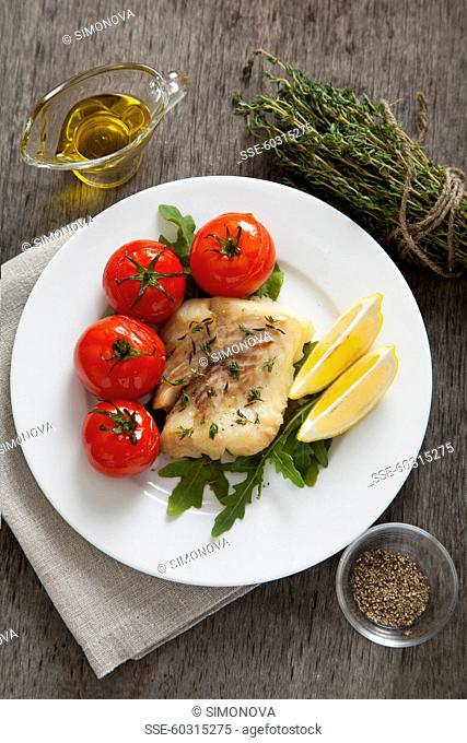 Hake with fresh thyme and baked tomatoes