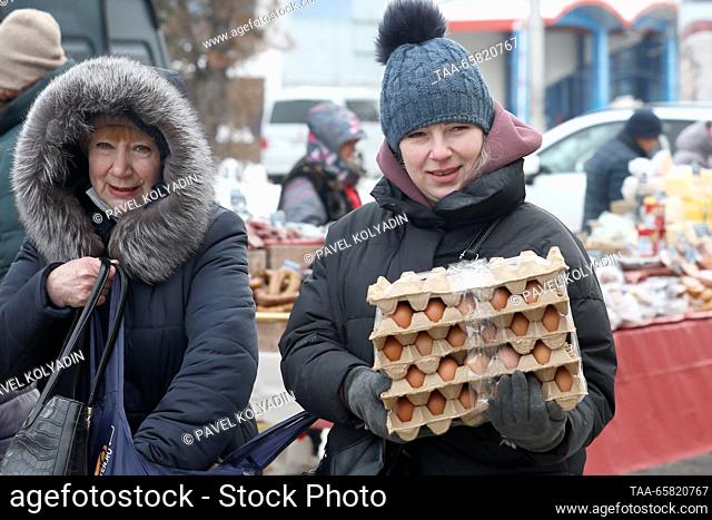 RUSSIA, BELGOROD - DECEMBER 16, 2023: A woman carries trays with eggs at a fair. Pavel Kolyadin/TASS