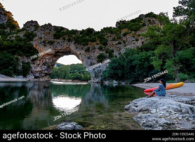 woman on the beach by the river in the Ardeche France Pont d Arc, Ardeche France, view of Narural arch in Vallon Pont D'arc in Ardeche canyon in France Europe