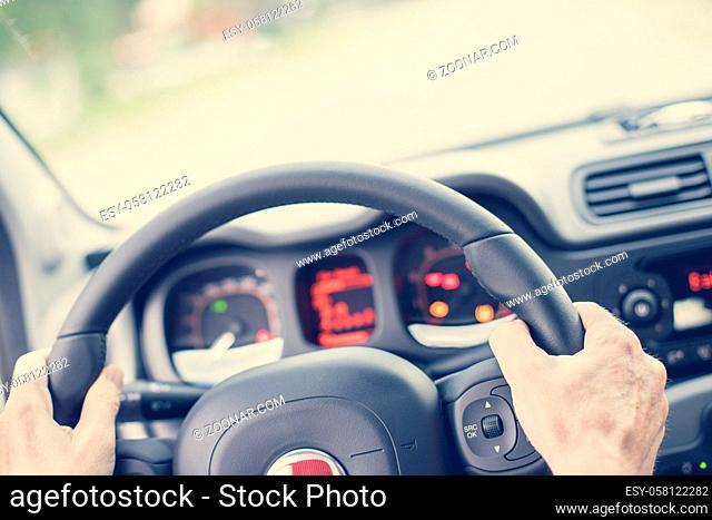 Sports car steering wheel, male hands steering