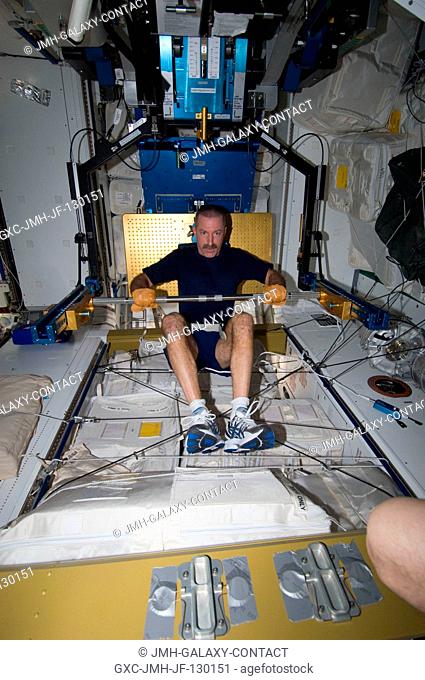 NASA astronaut Dan Burbank, Expedition 30 flight commander, exercises, using the advanced Resistive Exercise Device (aRED) in the Tranquility node of the...