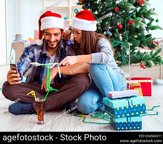 The young pair taking selfies during christmas