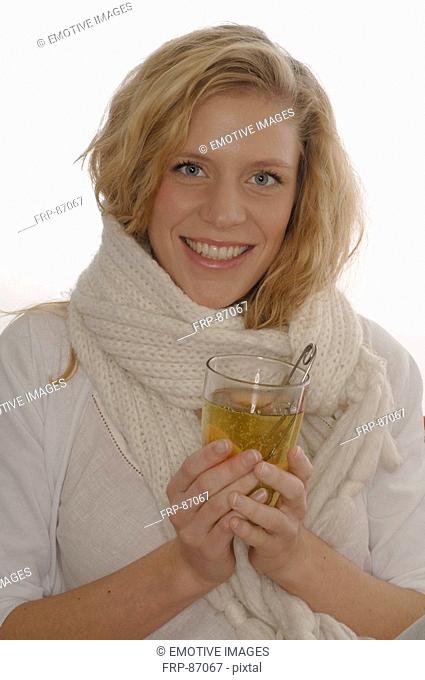 Woman worming up at a tea mug