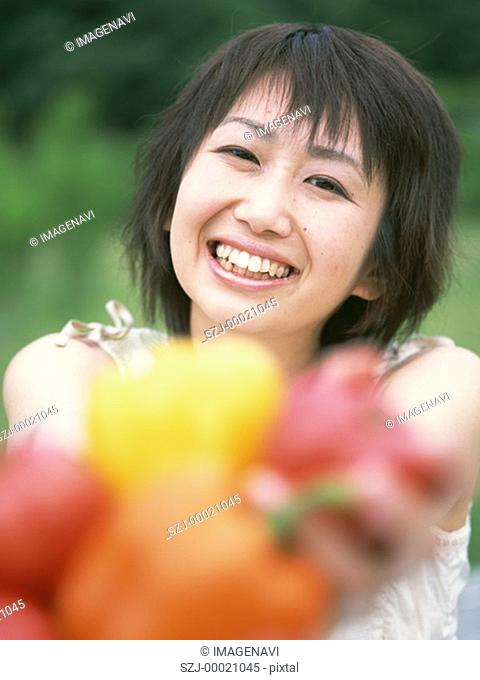 Woman holding out vegetables