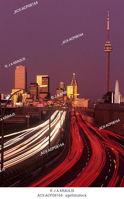 Dusk and rush hour traffic with skyline of Toronto, Ontario, Canada