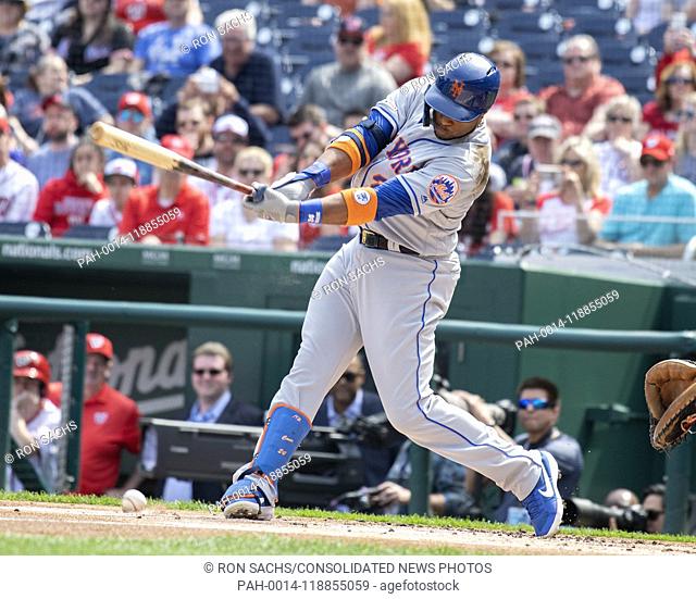 New York Mets second baseman Robinson Cano (24) swings at a pitch in the dirt in the first inning against the Washington Nationals at Nationals Park in...