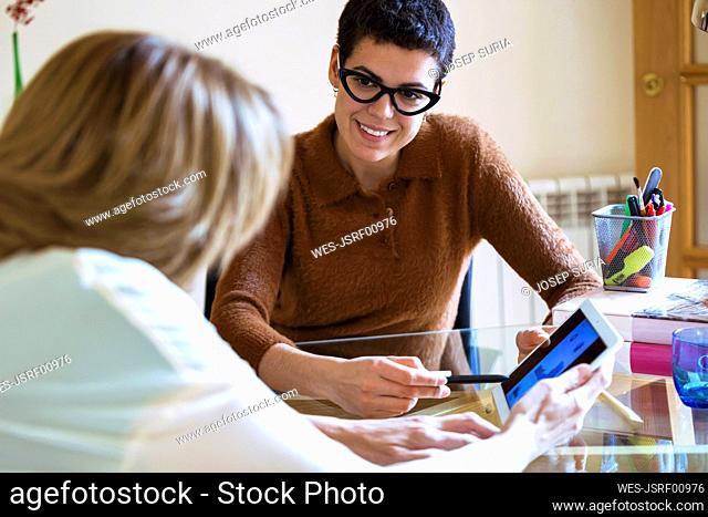 Businesswomen working in office using tablet