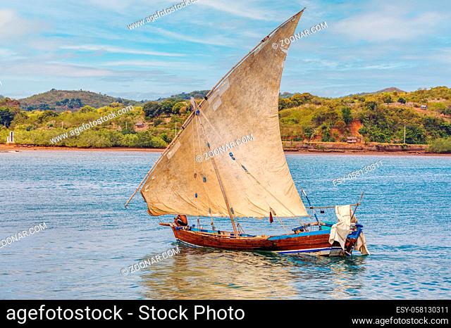 Malagasy fisher man on sea in traditional handmade dugout wooden sailing boat. Everyday life on Nosy be island. Nosy be, Madagascar