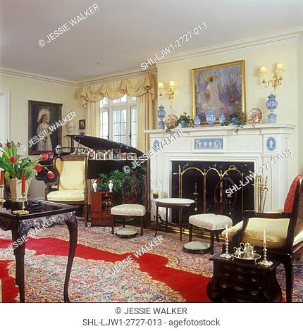 LIVING ROOMS - Formal living room, Louis XV style chairs, grand piano, antiques, white fireplace mantel with wedgewood insets, Oriental rug, yellow walls