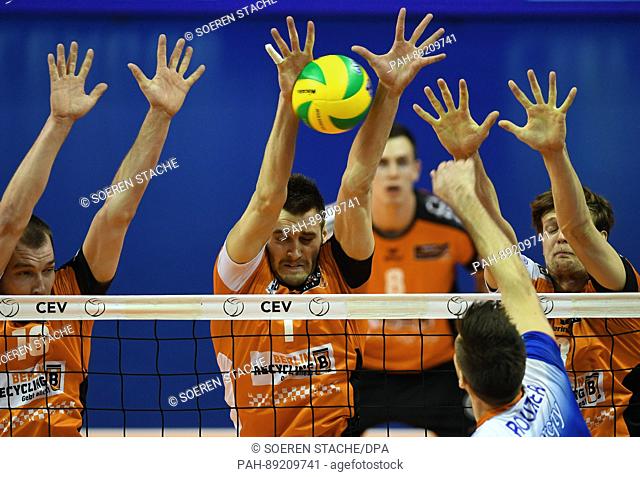 Berlin's Wouter Ter Maat (l-r), Aleksandar Okolic and Robert Kromm defend a ball played by Istanbul's Antonin Rouzier during the men's volleyball Champions...