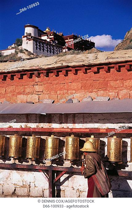 Prayer wheels along outer wall of Potala Palace, Lhasa. Tibet, China