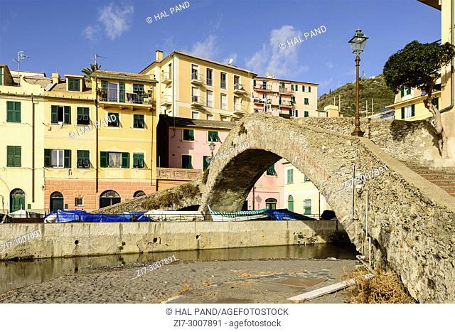 ancient Roman stone bridge and historical traditional houses, shot on a sunny winter day at Bogliasco, Genova, Italy
