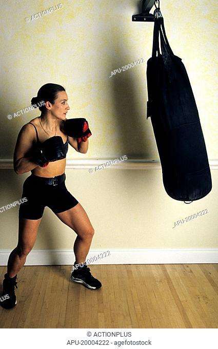 Woman working out with a punch bag