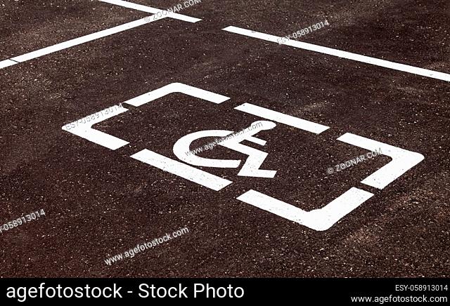 Parking places with handicapped or disabled signs and marking lines on asphalt