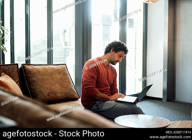 Businessman using laptop working in office